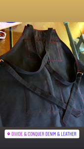 “My name is Sue, How do you do” Black denim & cognac leather crossback apron